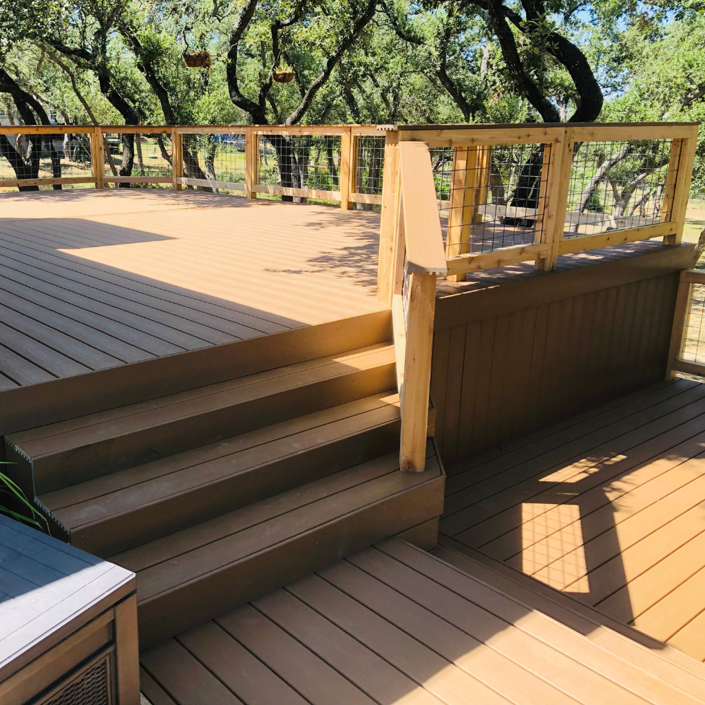 Custom-built wooden deck with seating area shaded by trees in San Antonio.
