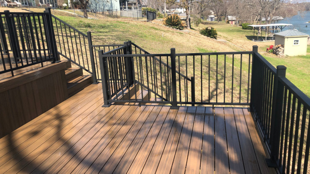 Elevated wooden deck with railing overlooking a scenic area